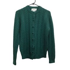 "GARFINCKEL'S Vintage Cable Knit Cardigan Sweater  Style: Grandmacore Cable Knit Cardigan Sweater Detail: Medium cableknit wool, very soft hand-knit feel | Crew neck with classic fit | Sweet matching wool-covered buttons Color: Emerald green Fabric: 100% wool Size marked European 38, approximately women's XS-S Approximate measurements laying flat: Pit to pit: 20\" Sleeve shoulder to wrist: 26\" Length: 23\" Excellent/like new vintage condition. No holes/stains/flaws/pilling." Classic Green Wool Cardigan, Green Fitted Wool Cardigan, Casual Wool Knitted Cardigan, Classic Green Knitted Sweater, Green Wool Knitted Cardigan, Classic Green Cable Knit Sweater, Classic Knit Cardigan For Winter, Casual Hand Knitted Wool Cardigan, Fitted Green Cable Knit Cardigan