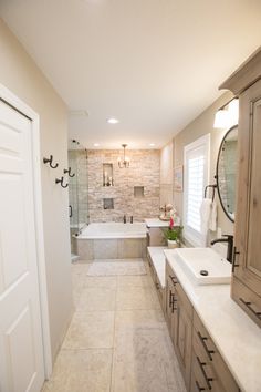 a large bathroom with two sinks and a bathtub