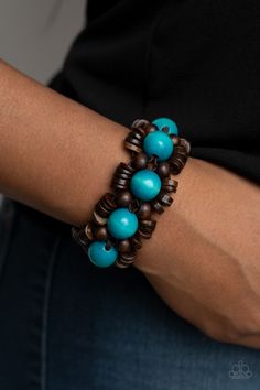 Oversized blue wooden beads, rustic brown wooden beads, and dainty wooden discs are ornately threaded along braided stretchy bands around the wrist, creating a summery centerpiece.

 Sold as one individual bracelet. Paparazzi Jewelry Images, Faux Rock, Wooden Bracelet, Wood Bracelet, Suede Tassel, Blue Wood, Paparazzi Accessories, Rustic Brown, Chic Jewelry