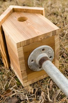 a wooden box with a metal handle on the ground