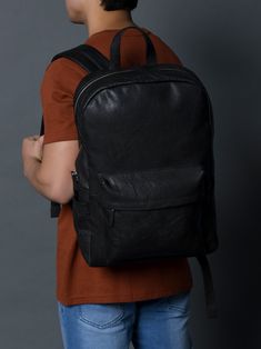 Indulge in timeless elegance with our NoirTrek Leather Backpack 1.0. Crafted in sophisticated black leather, this backpack effortlessly complements any outfit while providing ample storage. Its minimalist yet edgy design caters to the tastes of the youth, featuring clean lines and a contemporary silhouette. The backpack boasts a streamlined profile that remains on-trend while maintaining a sense of timelessness. The carefully chosen details, such as the silver zipper and snap closures gives it, Classic Leather Backpack For On-the-go, Classic Black Leather Backpack, Black Leather-lined Backpack, Black Leather-lined Standard Backpack, Black Backpack With Leather Lining, Classic Black Backpack, Classic Black Leather Backpack For Daily Use, Black Leather-lined Backpack For On-the-go, Classic Black Backpack For Daily Use