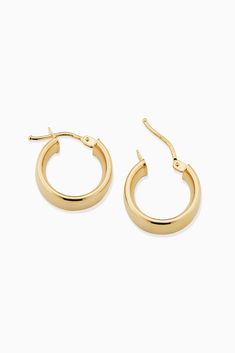 The One Hoops are easy to love. With a sleek design, these hoops will add polished shine to any ear stack or stand out solo as your go-to earrings. Metal: 14k Yellow Gold Dimensions: 6mm Tube, 10mm Inner Diameter Weight: 1.6 Grams Origin: Crafted in Arezzo, Italy Classic Huggie Earrings With Spring Ring Clasp For Anniversary, Classic Small Hoop Huggie Earrings With Polished Finish, Classic 14k Gold Huggie Earrings, Classic 14k Gold Hoop Earrings, Classic Oval Huggie Earrings With Polished Finish, Classic 14k Gold Earrings With Shiny Finish, Classic Small Hoop Huggie Earrings In 14k Gold, Classic Small Hoop Earrings With Polished Finish, Classic Earrings With Shiny Finish