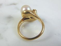 A LOVELY, WOMEN'S VINTAGE 14K GOLD RING WITH WHAT APPEARS TO BE PEARLS ACCENTED WITH TWO TINY DIAMOND CHIPS. NOT 100% SURE IF THE PEARL IS REAL OR NOT. THE DIAMONDS ARE REAL, ABOUT .02cts. THE RING IS A SIZE 3, AND WEIGHS 4.1g. THIS IS A BEAUTIFUL, IMPRESSIVE GIFT FOR THAT SOMEONE SPECIAL. ANY OTHER QUESTIONS, PLEASE DON'T HESITATE TO ASK. BE SURE TO CHECK OUT SOME OF MY OTHER GREAT ITEMS UP FOR SALE. THANK YOU. IF THERE ARE ANY ISSUES PLEASE CONTACT US, WE'RE ALWAYS HAPPY TO TRY TO HELP YOU OUT Heirloom High Luster Rings For Anniversary, High Luster Rings For Anniversary, Vintage Hallmarked Pearl Ring, 14k Gold High Luster Wedding Rings, Anniversary Pearl Ring With 17 Jewels, Yellow Gold Wedding Rings With High Luster, Estate Yellow Gold Wedding Jewelry, 14k Gold Hallmarked Pearl Ring, Antique Pearl Ring For Formal Occasions