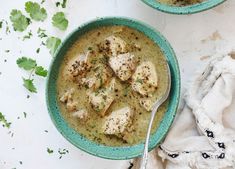 two bowls filled with soup on top of a table