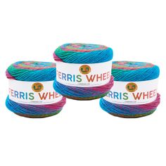 three balls of yarn with the words ferriss wheel written on them in blue, pink and