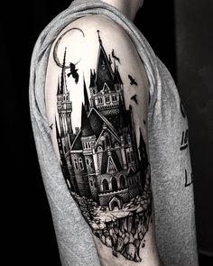 a man with a castle tattoo on his arm