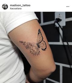 a woman's arm with a butterfly tattoo on the left side of her arm