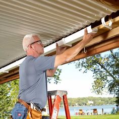 a man working on the roof of a house