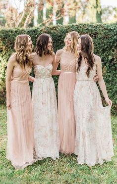 three bridesmaids are laughing together in their wedding gowns and one is wearing a strapless dress