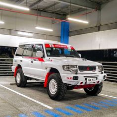 a white suv parked in a parking garage