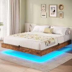 a bed with blue lights underneath it in a room next to a window and rug