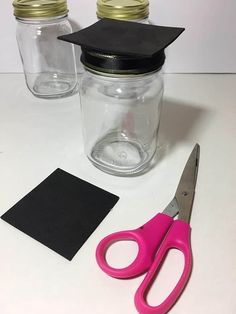 a pair of pink scissors and some mason jars