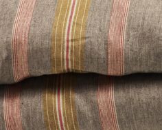 two brown and red striped pillows on top of each other