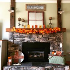 a fireplace with candles and decorations on it in a room that is decorated for fall