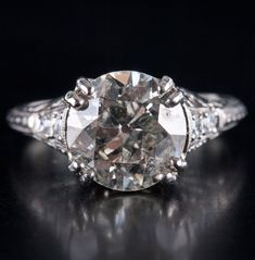 Vintage 1900's Platinum H SI2 Transitional Diamond Engagement Ring 3.10ctw 3.95gMetal Information: .900 PlatinumTotal Weight: 3.95gBand Width: 1.40mmSize: 6.75Circa: 1900'sAdditional Information: Girdle Abraded / Shows WearStone InformationMain StoneGem Type: DiamondShape: Transitional Round (9.3mm)Color: HClarity/Quality: SI2Carat Weight: 2.94ctNumber of Stones: 1Accent StonesGem Type: DiamondShape: Round (2.0mm)Color: HClarity/Quality: SI2Carat Weight: .03ctNumber of Stones: 4Accent StonesGem Antique Gia Certified Diamond Ring, Jewelry Website, Custom Jewelry Design, Beautiful One, Estate Jewelry, Diamond Engagement Ring, Diamond Shapes, Diamond Engagement, Diamond Engagement Rings