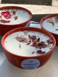 three red bowls filled with food sitting on top of a table next to each other