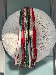 a wreath with ribbons hanging from it's side