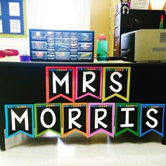 a desk with the words mrs morri's spelled out in bright colors on it