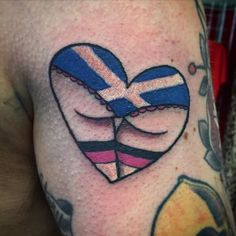 a heart shaped tattoo with the flag of scotland on it