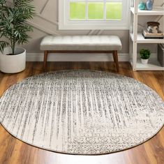 a round rug in the corner of a room with a bench and potted plant