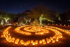 many lit candles are arranged in the shape of a maze