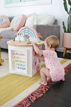 a toddler playing with a toy house