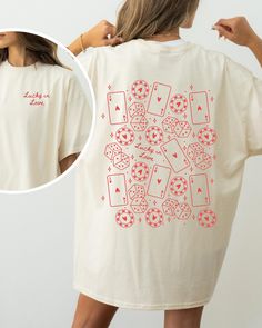 a woman wearing a t - shirt with playing cards on it