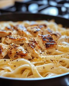 pasta with chicken and parmesan cheese in a skillet