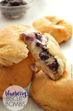 blueberry biscuits are cut in half and placed on a white counter top