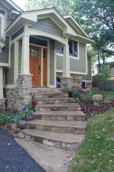 a house with stone steps leading up to the front door