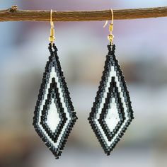 Handcrafted by artisan Angeles Gonzalez from Mexico, these gorgeous diamond-shaped dangle earrings are perfect to complement any outfit. Angeles places each glass bead meticulously to form a black and white geometric pattern that embellishes these graceful earrings with 14k gold-plated hooks. Black And White Geometric Pattern, Buy Bead, Beaded Dangle Earrings, Diamond Shaped, Beaded Dangles, Hook Earrings, Glass Bead, Diamond Shapes, Beaded Earrings