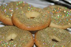 there are four donuts with glitter on them