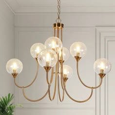 a chandelier with five globes hanging from it's center and four lights on each side