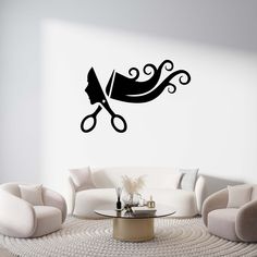 a living room with white furniture and a wall sticker that has scissors on it