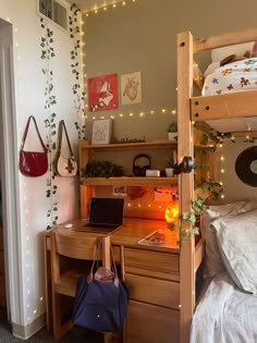 a bedroom with two bunk beds, a desk and a laptop on top of it