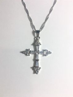 "Beautiful Tanzanite Cross Pendant Necklace, Tanzanite & CZ Cross Pendant Necklace 18\" White Gold Plated Wave Chain. The Cross pendant has White Topaz and Clear Cubic Zirconia. The Cross is 1 1/2\" High x 1\" Wide Please ask any questions as I do not accept returns.. Thank You !" Silver Cubic Zirconia Necklace With Stone Setting, Silver Cubic Zirconia Necklace With Stones, Spiritual Cubic Zirconia Necklaces With Diamond Accents, Silver Crystal Cross Pendant Necklace, Silver Spiritual Necklace With Cubic Zirconia, Crystal Clavicle Chain With Cross Pendant, Crystal Cross Pendant Clavicle Chain, Spiritual Silver Necklace With Cubic Zirconia, Spiritual Silver Cubic Zirconia Necklace