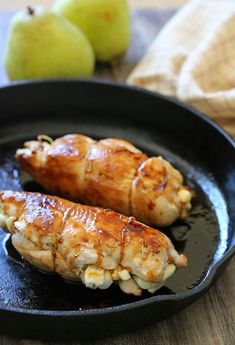 two pieces of chicken in a frying pan