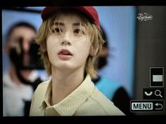 a young man wearing a red hat on top of a tv screen