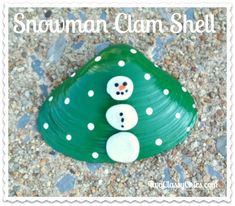 a green rock with two snowmen on it and the words, snowman clam shell