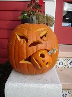 a carved pumpkin sitting on top of a cement block