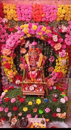 an idol surrounded by flowers and other decorations