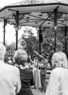 a group of people that are standing in front of a gazebo