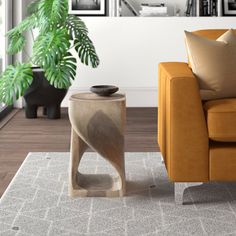 a living room with a couch, table and potted plant in the corner next to it