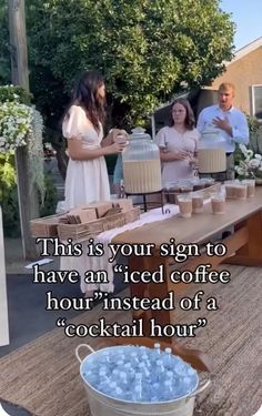 people standing around a table with drinks and cake on it that says, this is your sign to have an iced coffee hour instead of a cocktail hour