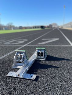 an empty parking lot with no cars or people on it, and two metal brackets attached to the ground