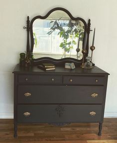 a dresser with a mirror on top of it