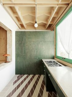 an instagram photo of a kitchen with green and white tiles on the floor,