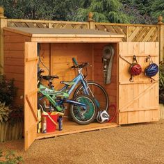 a wooden shed with two bikes in it