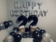 a birthday decoration with black and silver balloons