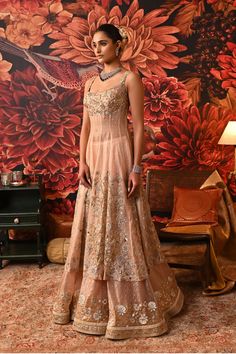 ‘Ethereal beauty’, is the word that comes instantly to mind while looking at this blush pink Anarkali. The Anarkali is a compilation of multi-generation vibes smoothly crafted in golden and silver embroidery work with floral motifs. Pair it up with some statement jewelry and watch everyone go gaga over your style. Sleeveless Anarkali kurta with dabka and nakshi embroidered yoke and hem SS zip closure in Anarkali and skirt Silver foil printed skirt with embroidery at the hem Floral embroidered pa Silver Embroidery Work, Sleeveless Anarkali, Skirt With Embroidery, Pink Anarkali, Silver Foil Printing, Silver Embroidery, Anarkali Kurta, Printed Skirt, Silk Organza